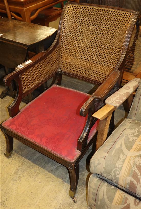 A pair of Regency style mahogany bergere armchairs (formerly from the Brighton Grand Hotel), W.63cm, D.80cm, H.90cm